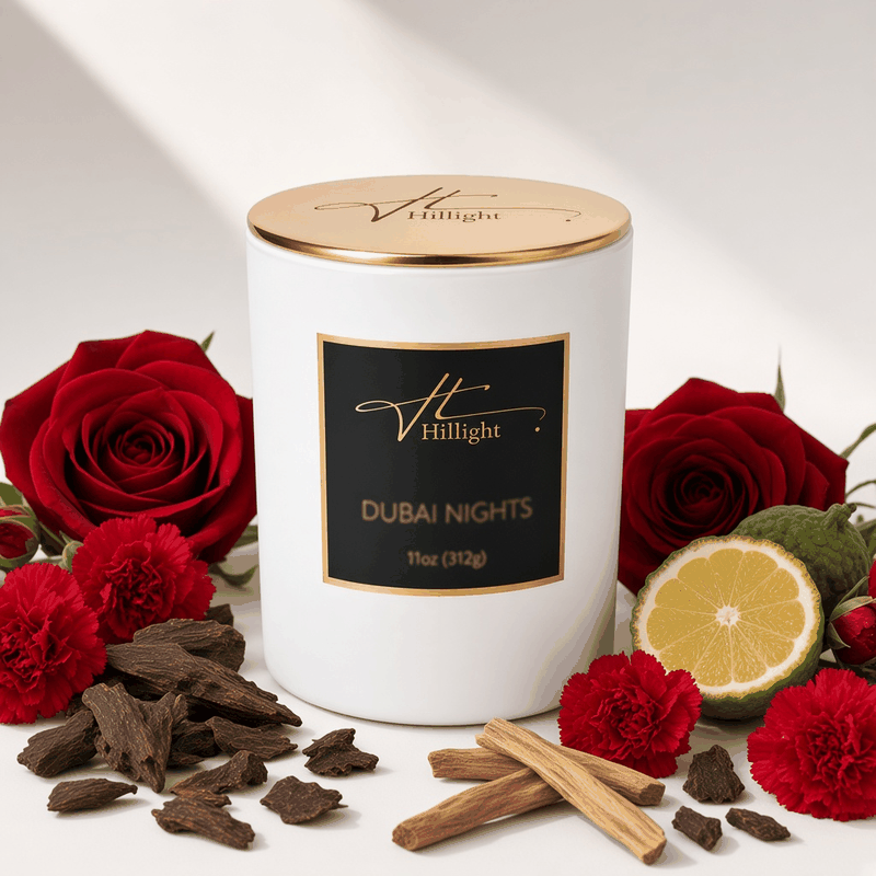Dubai Nights white Hillight oud candle with gold lid surrounded by red roses, oud wood and citrus