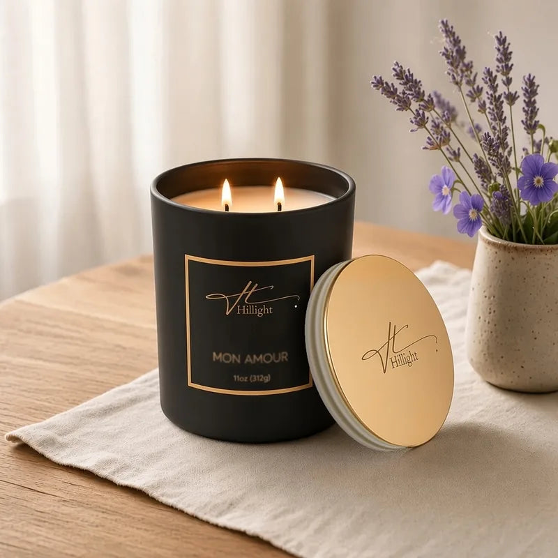 Lit Mon Amour double-wick luxury candle in a black jar with its gold lid